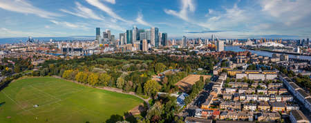 Aerial panoramic view of the Canary Wharf business district in London, UK.