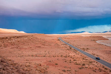 Scenic view of highway through desert against dramatic sky in summerの写真素材