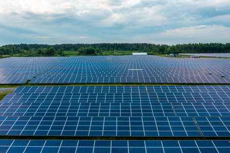 Huge solar power plant to use solar energy in a picturesque green field in Ukraine.