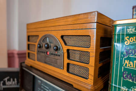 Antique old fashion style wooden radio speaker beside wall in house