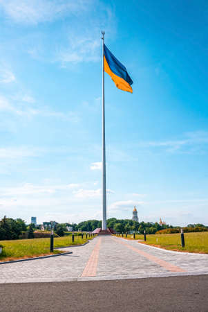 Bicolor blue and yellow national flag of ukraine waving in wind against skyの写真素材