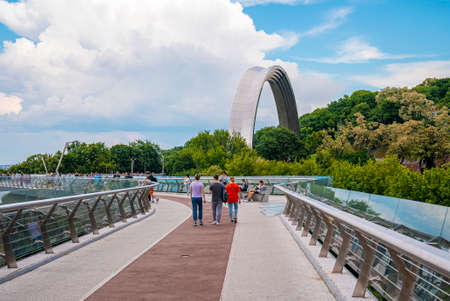 Tourists walking on pedestrian bridge by Peoples Friendship Archの写真素材
