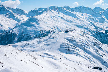 Aerial view of ski lift and skiers on snow covered hill slopeの写真素材