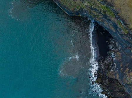 Iceland black sand beach with huge waves at Reynisfjara Vik.