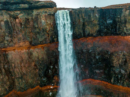 Aerial view on Hengifoss waterfall with red stripes sediments in Iceland.の写真素材