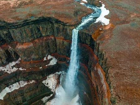 Aerial view on Hengifoss waterfall with red stripes sediments in Iceland.の写真素材