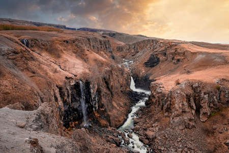 Idyllic view of Litlanesfoss waterfall in Eastfjords against sky during sunset