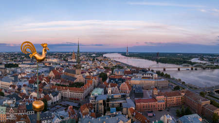 Golden cock on the top of the Dome Cathedral during sunset over Riga. Beautiful wallpaper.の写真素材