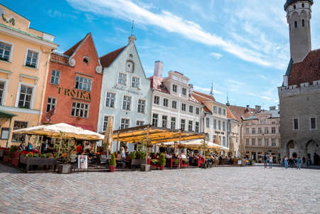 Travelers exploring market in city square at old historic town against skyの写真素材