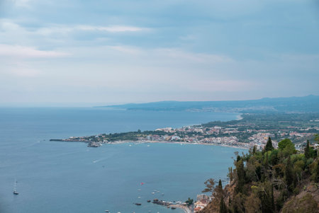 Beautiful scenery of landscape by sea with cloudy sky in backgroundの写真素材
