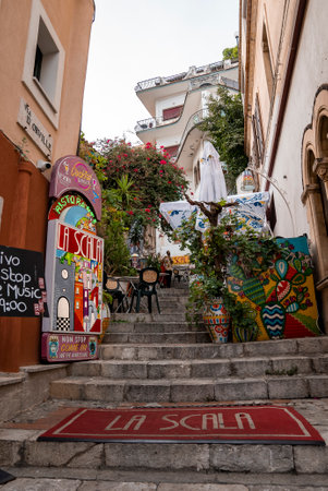 Beautiful art decorations on steps amidst old buildings in coastal townの写真素材