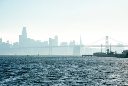 Scenic view of Bay Bridge and city skyline with clear sky in backgroundの写真素材