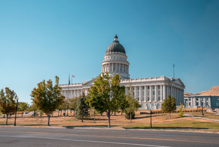 Empty road by State Capitol building with clear blue sky in background in summerの写真素材