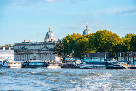 Boats and small ships docked on a river Thames in London, UK.の写真素材