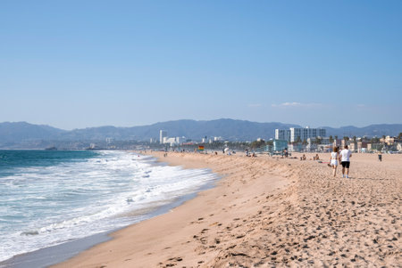 Scenic view of waves splashing on sandy beach at Los Angeles on sunny dayの写真素材