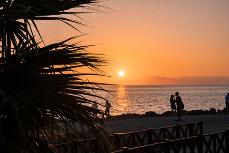 Scenic view of beautiful seascape with sun shining in clear sky at sunsetの写真素材