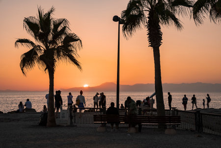 People enjoying at beach with scenic view of Mediterranean sea under clear skyの写真素材