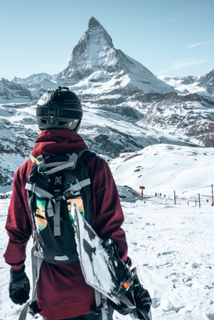 Young snowboarder spending winter holidays in Zermatt, near the famous Matterhorn peak.の写真素材