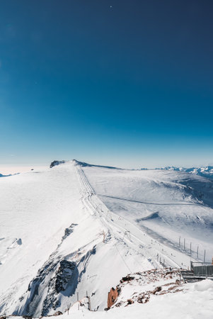 Ski slope and snow covered winter mountains. Matterhorn is a mountain in the Pennine Alps