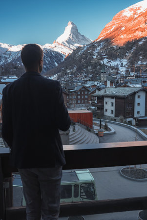 Cheerful man in a suit enjoying the view of the Matterhorn peak in Zermattの写真素材