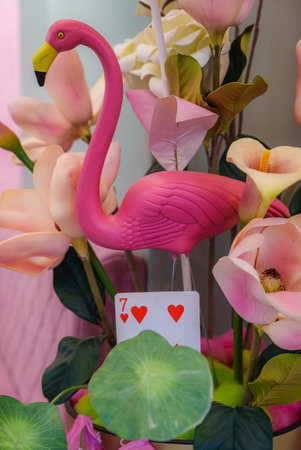 Pink flamingo statue decorated with colorful tropical summerの写真素材
