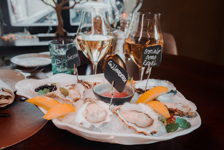 Fresh Oysters close up on a plate, served table with oysters, lemon and ice. Healthy sea food.の写真素材