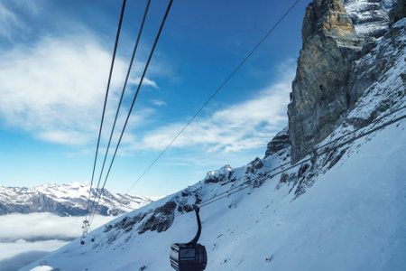 Cable car moving over snowcapped mountain at ski resort