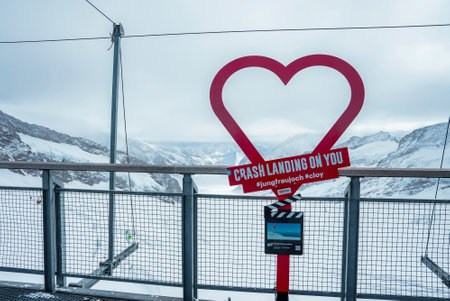Red heart shape with text against beautiful snowcapped mountainsの写真素材