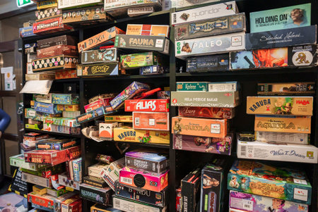 Several type colourful board game boxs on the shelves of games cafeの写真素材