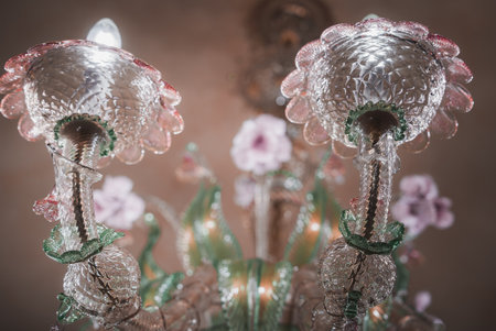 Exquisite Pink and Clear Glass Chandelier Adorned with Flowers in Luxurious Venetian Interiorの写真素材