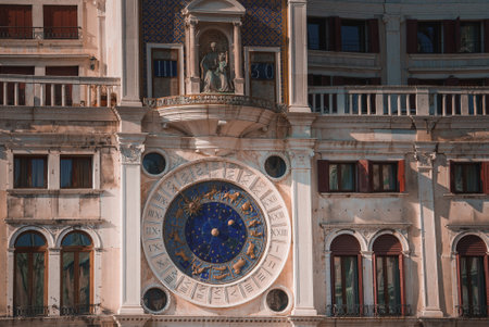 Historical Renaissance tower clock on ornate white building in Venice, Italy.