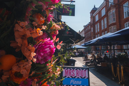 Colorful flower decoration outside shop in townsquare during sunny dayの写真素材