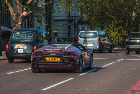 Cars moving on road in city during sunny dayの写真素材
