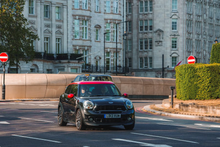 Man driving car by woman on road in city