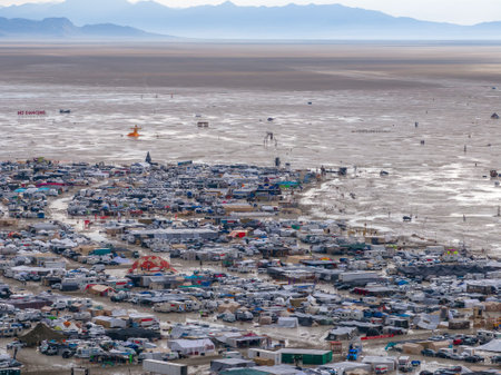 Aerial shot of a temporary settlement in a desert landscape with mountains in the background.の写真素材