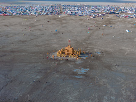Aerial view of the festival in a desert with beautiful art installations and people walking around.の写真素材