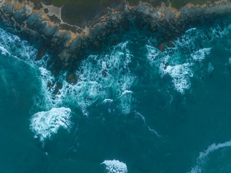 Aerial view of ocean waves hitting the shore