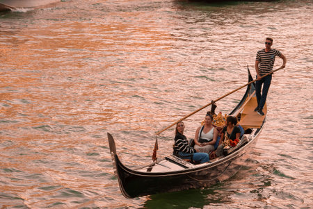 Leisurely Gondola Ride on Calm Waters of Venice, Italy - Relaxing Watercraft Experienceの写真素材