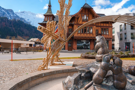 Serene Engelberg Town Square with Alpine Sculpture and Swiss Architecture