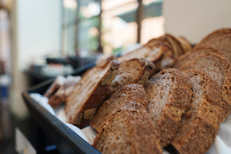 Luxury hotel buffet showcasing tray of crusty brown bread slices, Rome.