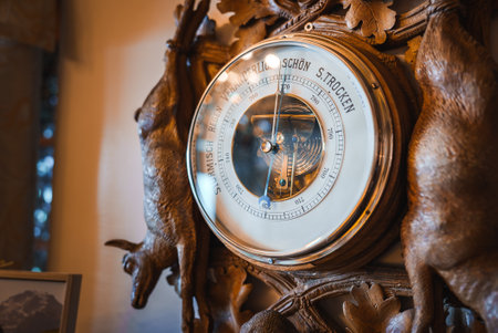 Ornate barometer with chamois motifs in vintage wooden frame, European craftsmanship.