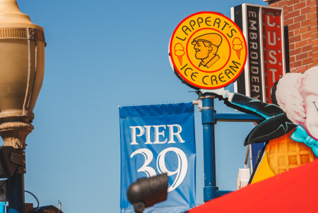Vibrant street scene with Lapperts Ice Creamery and Pier 39 signs in San Francisco.の写真素材