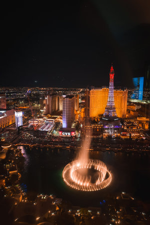 Aerial night view of vibrant Las Vegas Strip with Bellagio fountains, Eiffel Tower replica, and bright city lights creating dynamic, electric atmosphere.の写真素材