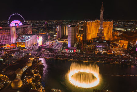 Aerial night view of iconic Las Vegas Strip with Bellagio fountains, Paris Las Vegas Hotel, and High Roller observation wheel. Glittering lights and vibrant atmosphere captured in cityscape.の写真素材