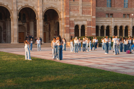 People gathering in historic courtyard of large academic buildingの写真素材