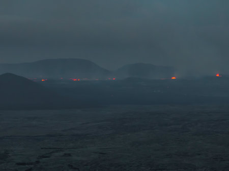 Aerial View of Misty Volcanic Landscape with Glowing Lava in Icelandの写真素材