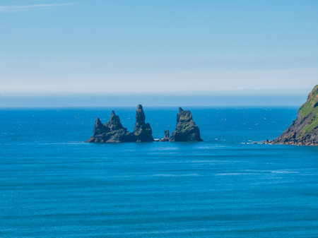 Three Rocky Islands with Green Vegetation in the Atlantic Ocean, Icelandの写真素材