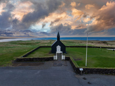 Aerial View of the Black Church in Budir, Iceland at Sunsetの写真素材