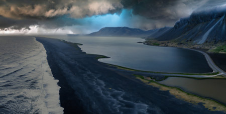 Aerial View of Black Sand Beach with Dark Blue Ocean and Lake in Icelandの写真素材