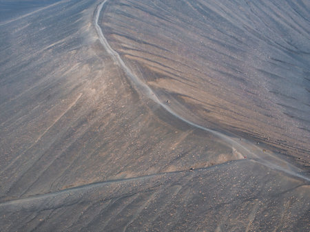 Aerial View of Winding Dirt Road Through Barren Rocky Landscape in Icelandの写真素材